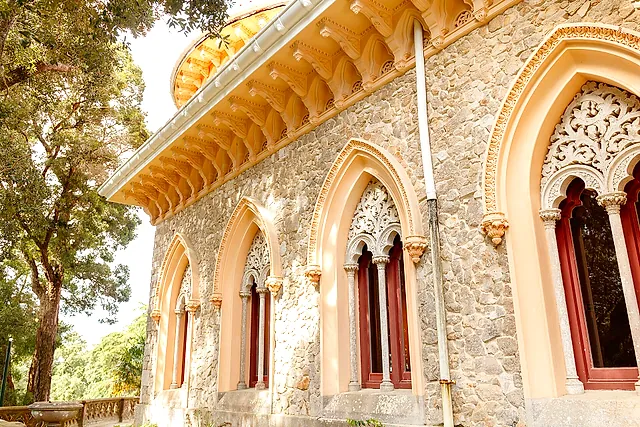 Carved Moorish-style windows and a scalloped cornice on the sunlit walls of Monserrate Palace