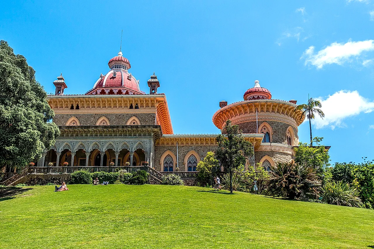 Monserrate Palace with its pink domes and arcades above a bright green lawn