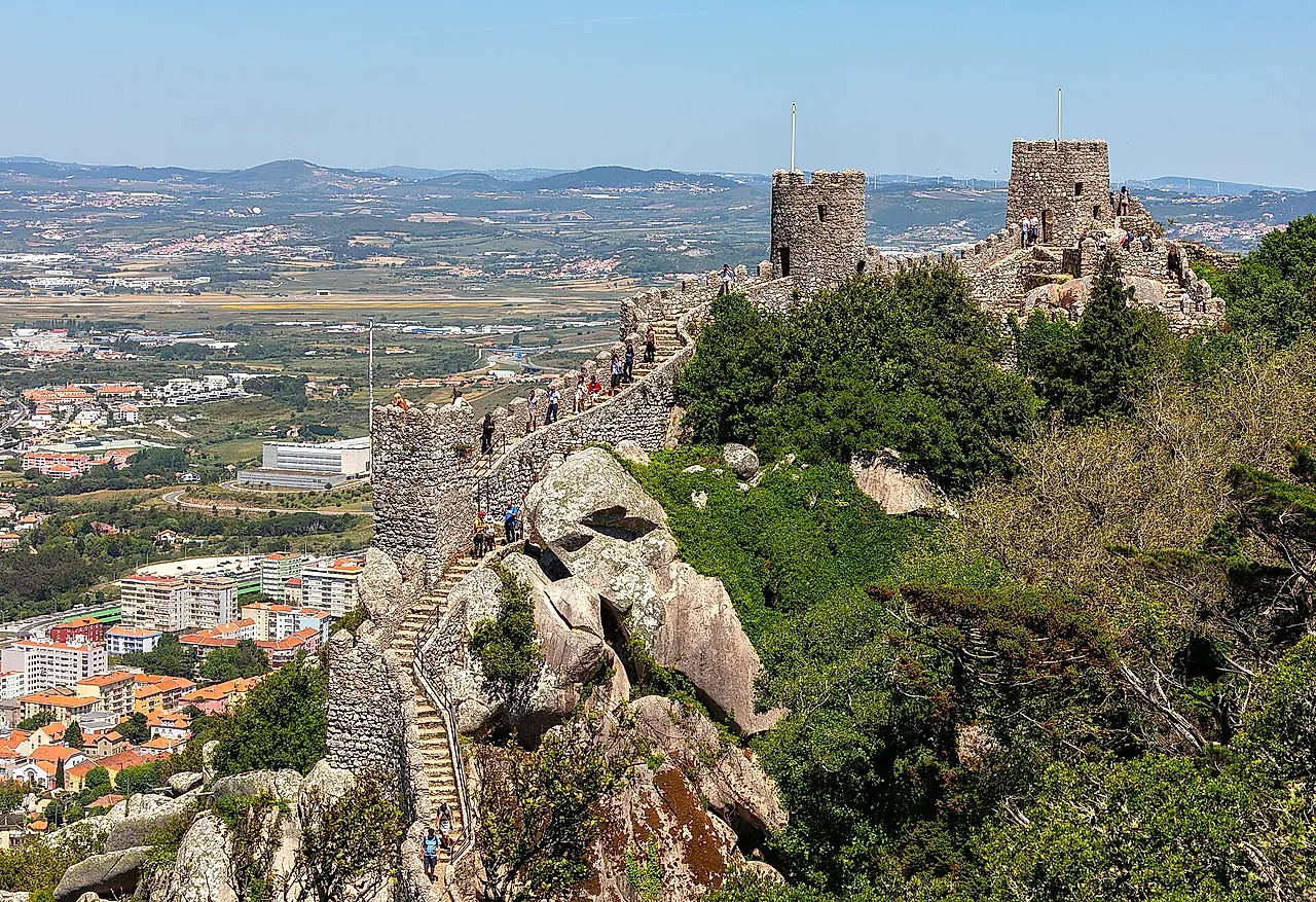 The walls and towers of the Castle of the Moors climbing over granite boulders above the plain