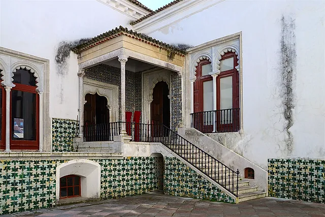 A tiled loggia and courtyard of the National Palace of Sintra with Moorish-style windows