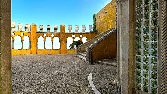Moorish-style arches and tiled walls on a sunny terrace of Pena Palace